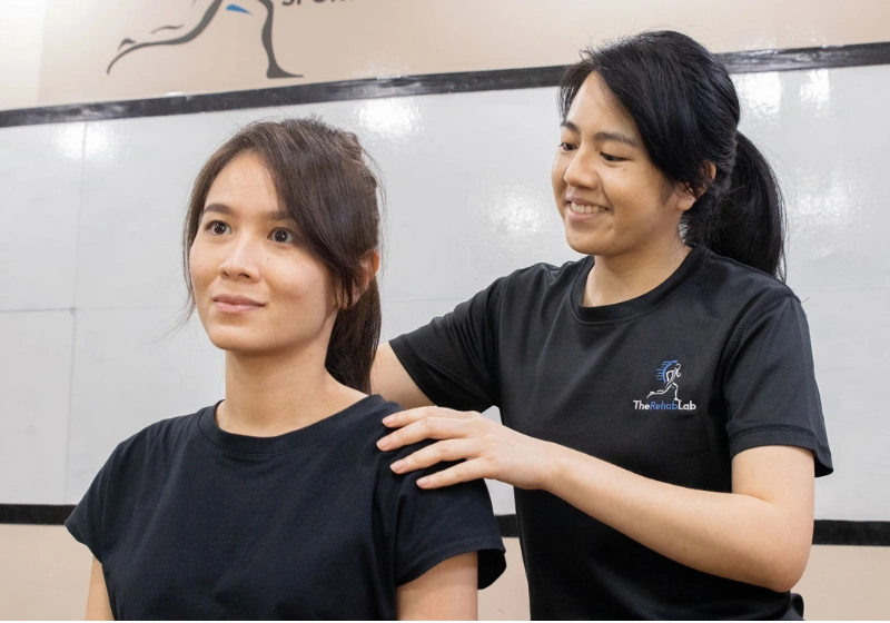 Physiotherapist giving hands-on shoulder and neck treatment