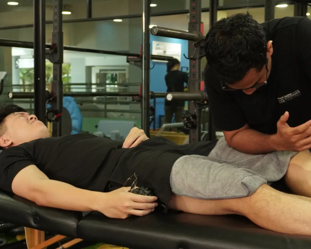 Therapist working with a client during a physiotherapy session